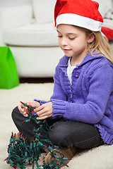 Image showing Girl In Santa Hat With Fairy Lights