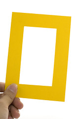 Image showing Hand holding a yellow frame

