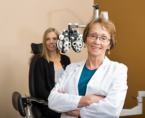 Image showing Female Optometrist With Patient In Background