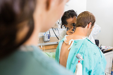 Image showing Doctor Using Otoscope To Examine Patient's Ear