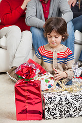 Image showing Boy Looking At Christmas Presents