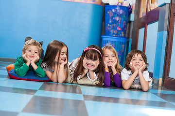 Image showing Boys And Girls Lying On Floor In Kindergarten