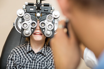 Image showing Boy Undergoing Eye Test With Phoropter