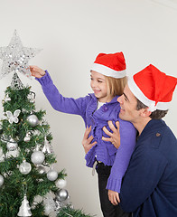 Image showing Father And Daughter Looking At Christmas Tree