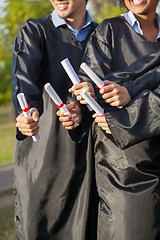 Image showing Students Holding Diplomas On Graduation Day In College