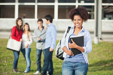 Image showing Female Student Holding Books On College Campus