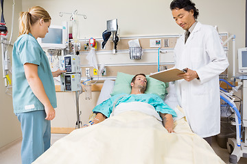 Image showing Doctor Examining Patient's Report