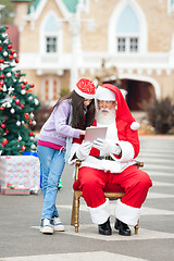 Image showing Girl And Santa Claus Using Digital Tablet