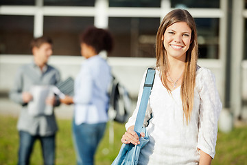 Image showing Woman Carrying Shoulder Bag With Students In Background On Campu