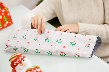 Image showing Woman Wrapping Christmas Gift