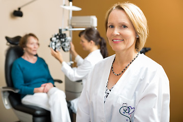 Image showing Confident Eye Doctor With Colleague Examining Patient