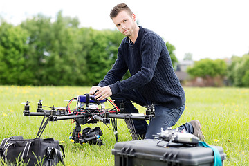 Image showing Young Engineer Preparing Spy Drone in Park