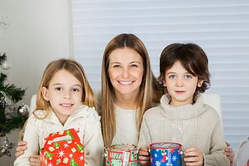 Image showing Happy Mother And Children With Christmas Gifts