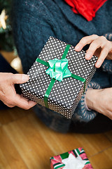 Image showing Couple Holding Christmas Present At Store