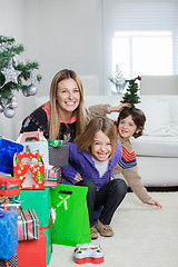 Image showing Mother With Children Sitting By Christmas Gifts