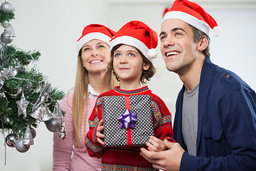 Image showing Parents With Boy Holding Christmas Present