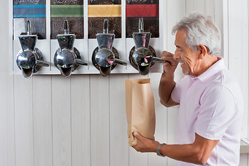 Image showing Senior Man Buying Coffee Beans At Grocery Store