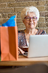 Image showing Senior Woman With Laptop In Coffeeshop