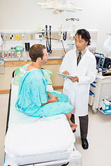 Image showing Doctor Discussing Report Over Digital Tablet With Patient