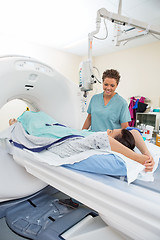 Image showing Nurse Looking At Patient About To Undergo CT Scan