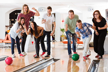 Image showing Young Friends Bowling While People Cheering