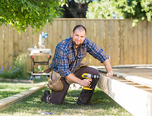 Image showing Manual Worker Drilling Wood At Construction Site