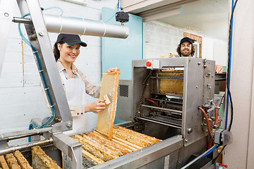 Image showing Happy Beekeepers Working At Honey Extraction Plant