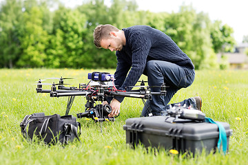 Image showing Engineer Setting Camera On UAV Helicopter