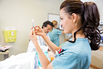 Image showing Medical Team Treating Patient In Hospital