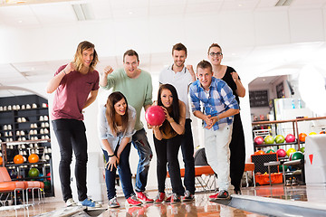 Image showing Woman Bowling While Friends Motivating in Club