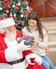 Image showing Girl Taking Christmas Gift From Santa Claus