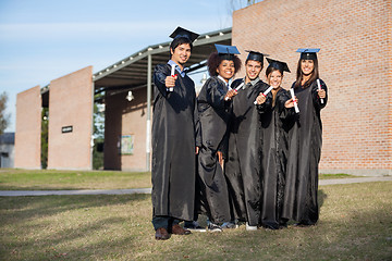 Image showing College Students Showing Diplomas Standing On Campus