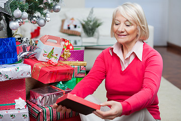 Image showing Senior Woman Looking At Christmas Gift