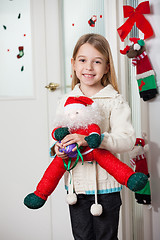 Image showing Girl With Santa Toy Standing At Home