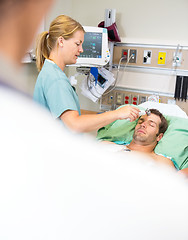 Image showing Nurse Examining Male Patient in Emergency