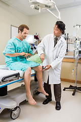 Image showing Neurologist Examining Patient's Knee With Hammer In Hospital