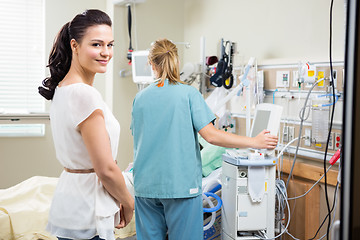 Image showing Woman With Nurse Examining Patient In Hospital