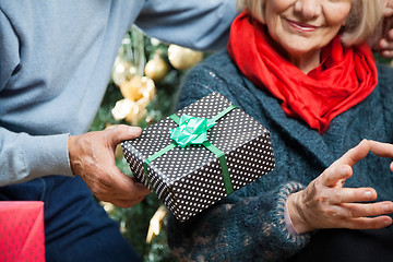 Image showing Man Giving Christmas Present To Woman At Store