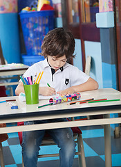 Image showing Boy Drawing With Student Sitting In Background
