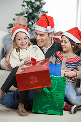 Image showing Siblings And Father With Christmas Presents