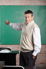 Image showing Teacher Pointing Towards Greenboard At Classroom