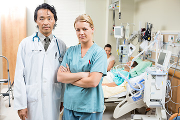 Image showing Confident Doctor And Nurse With Patient Resting In Hospital