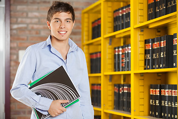 Image showing Confident Student Holding Books While Standing In Campus