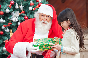 Image showing Santa Claus Giving Present To Girl