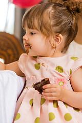 Image showing Girl Eating Cake With Icing On Her Face