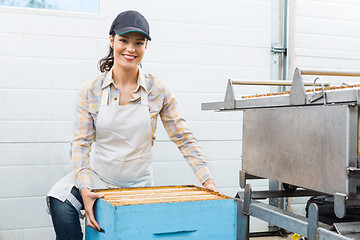 Image showing Female Beekeeper With Honeycomb Box At Factory