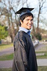 Image showing Happy Man In Graduation Gown On University Campus