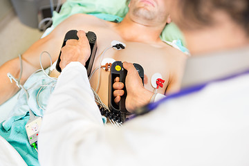 Image showing Doctor Defibrillating Male Patient In Hospital