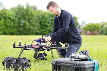 Image showing Engineer Preparing Surveillance Drone in Park