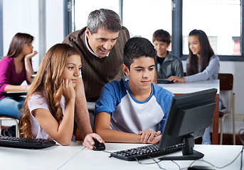 Image showing Male Teacher Assisting Students In Computer Class